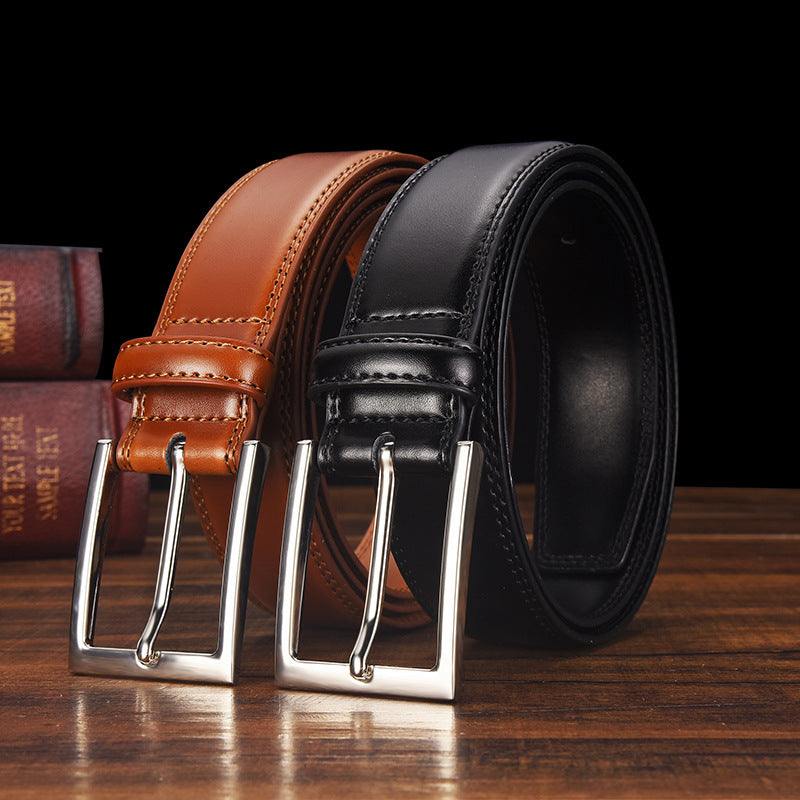 Two men's genuine leather belts in black and brown with alloy pin buckles on a wooden surface