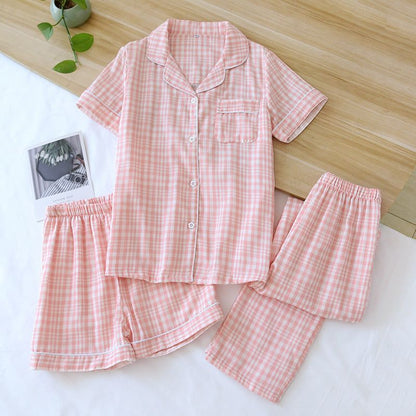Three-piece cotton gauze pajamas for women in light pink check pattern with short sleeves, shorts, and trousers laid out on a white surface.