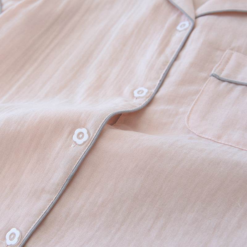 Close-up of light pink three-piece cotton gauze pajamas with button and pocket detail for women