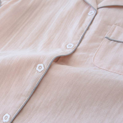 Close-up of light pink three-piece cotton gauze pajamas with button and pocket detail for women