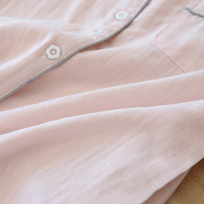 Close-up of light pink three-piece cotton gauze pajamas for women with flower-shaped buttons