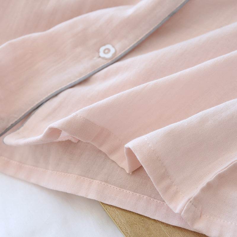 Light pink three-piece cotton gauze pajamas detail with button and soft fabric texture