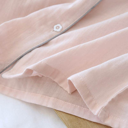 Light pink three-piece cotton gauze pajamas detail with button and soft fabric texture